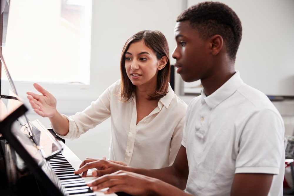 Piano tutor with student