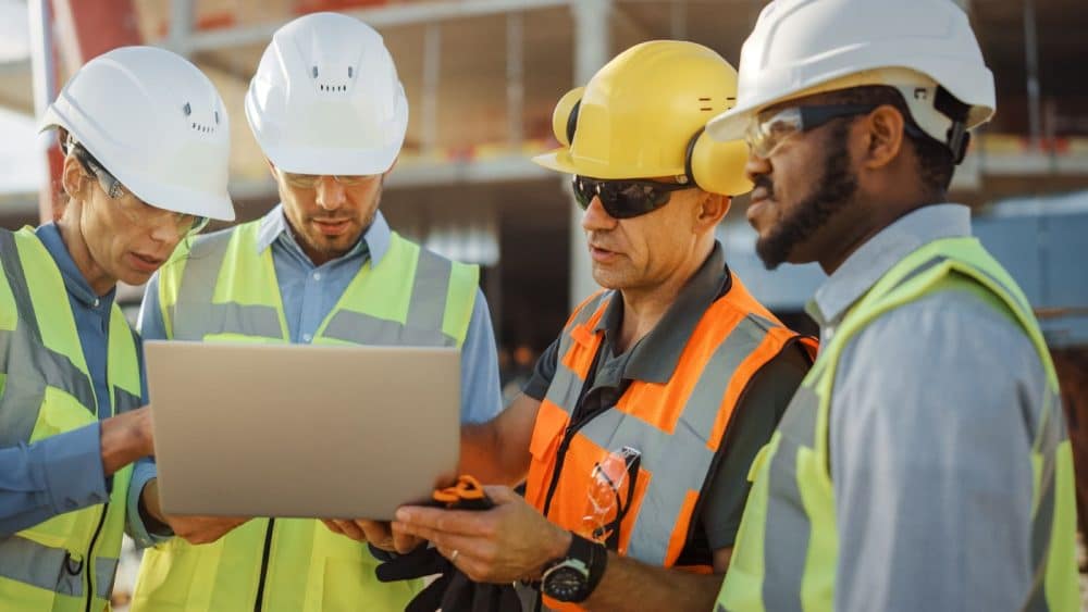 Construction workers with EO insurance paperwork